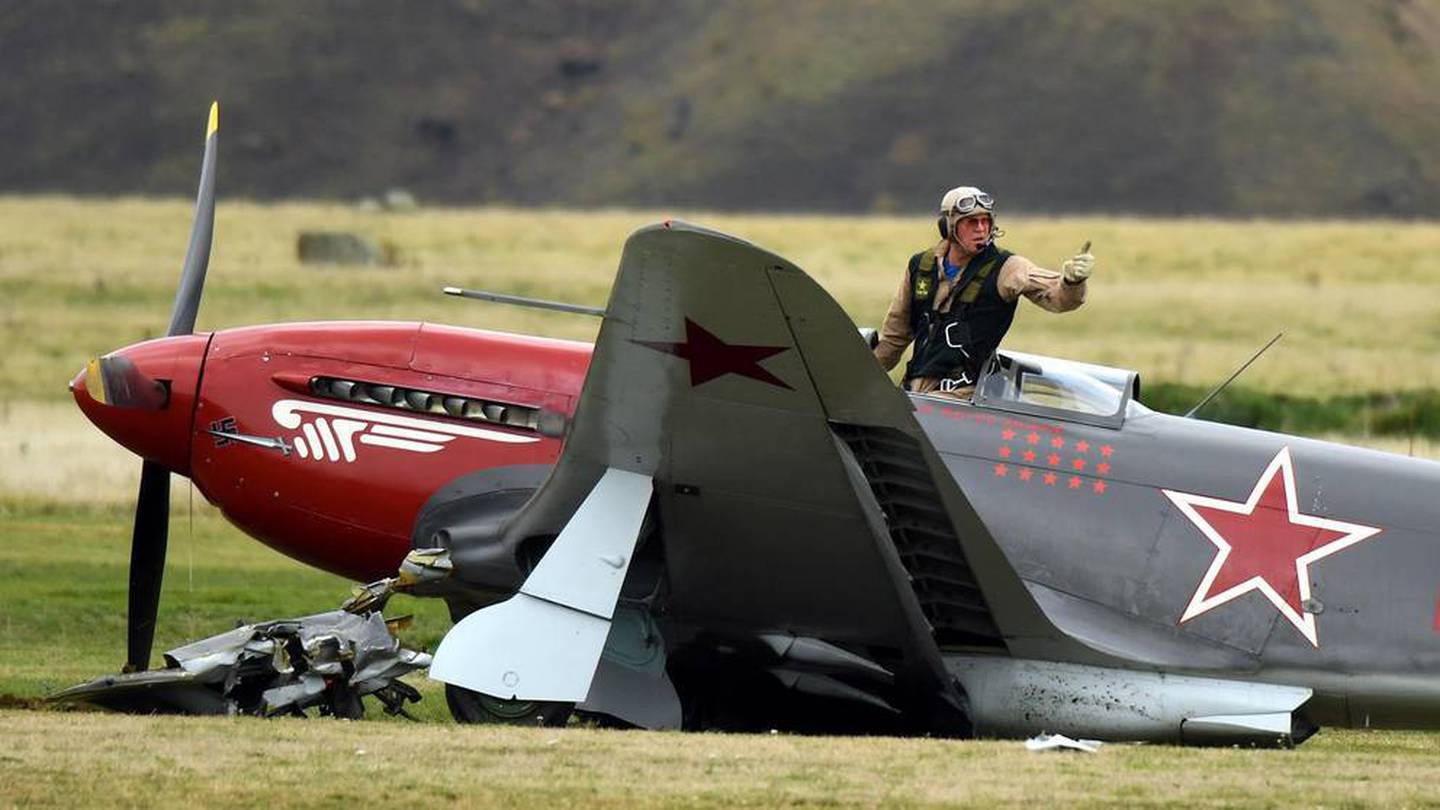 Arthur Dovey signals he's unhurt after his vintage plane collided with a cherry picker in 2018....