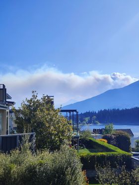 Smoke is seen coming over the hills from a large fire at Mt Creighton, Glenorchy. Photo: Regan...