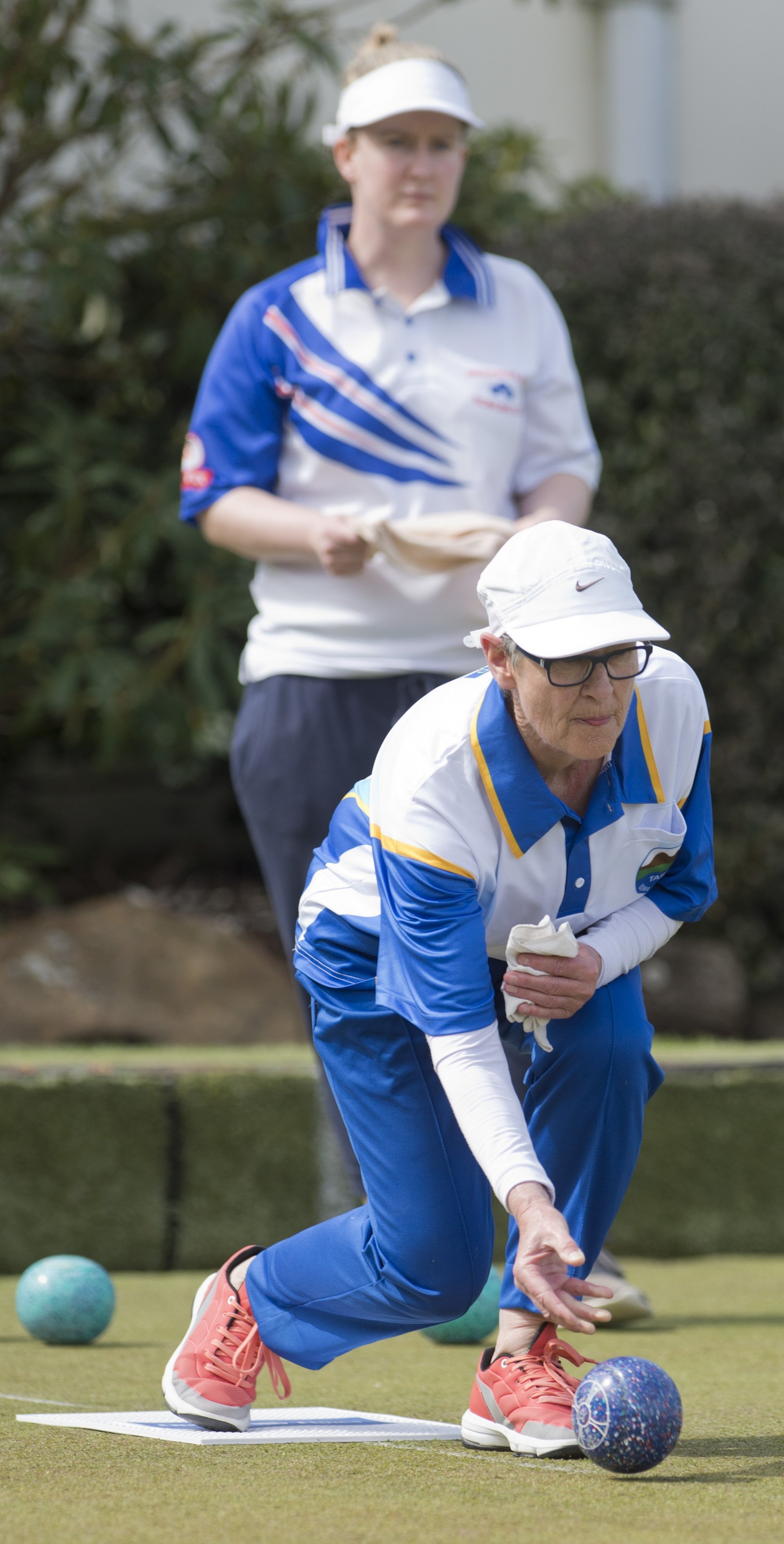 Tournament winner Jan Hall delivers her bowl as opposing skip Shannon Eathorne looks on during...