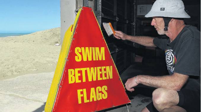 Dusting off . . . Waikuku Surf Life Saving Club life guard Andy MacFarlane gears up for the new...