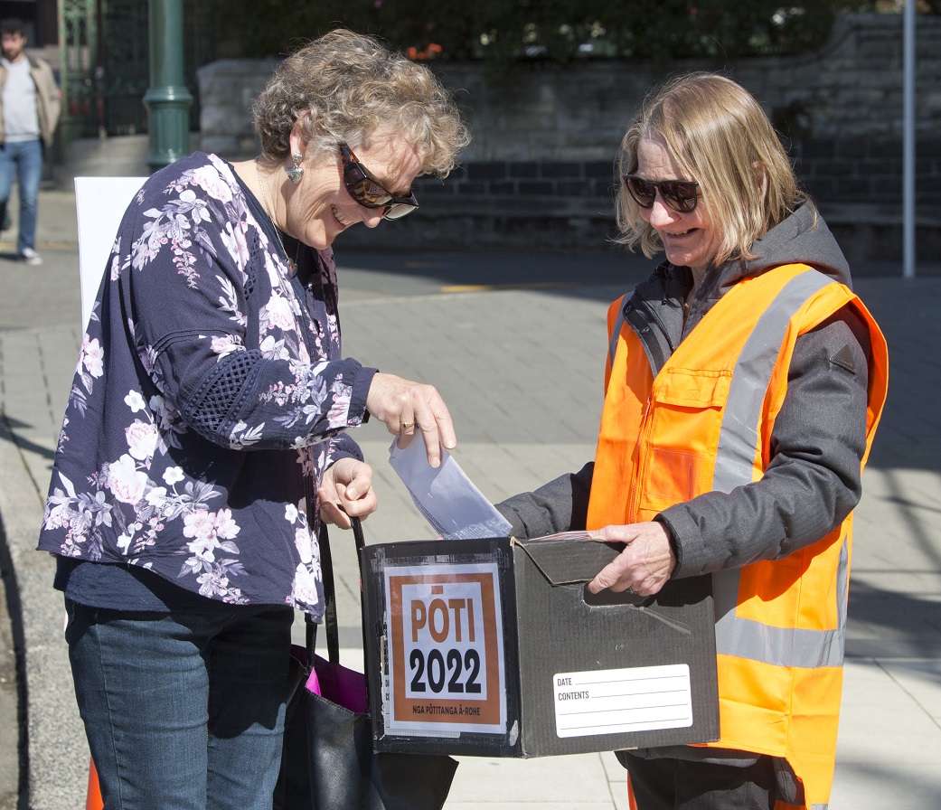 Dunedin resident Jan Nimmo (left) casts her local body election votes in the Octagon this morning...