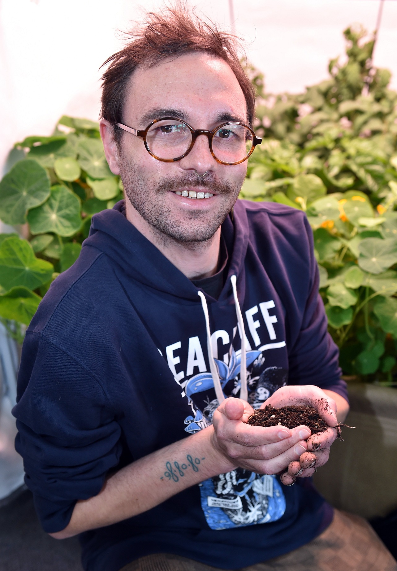 Seacliff Organics’ Cody Peneamene with a handful of soil at the Vogel St Garden Centre in Dunedin...