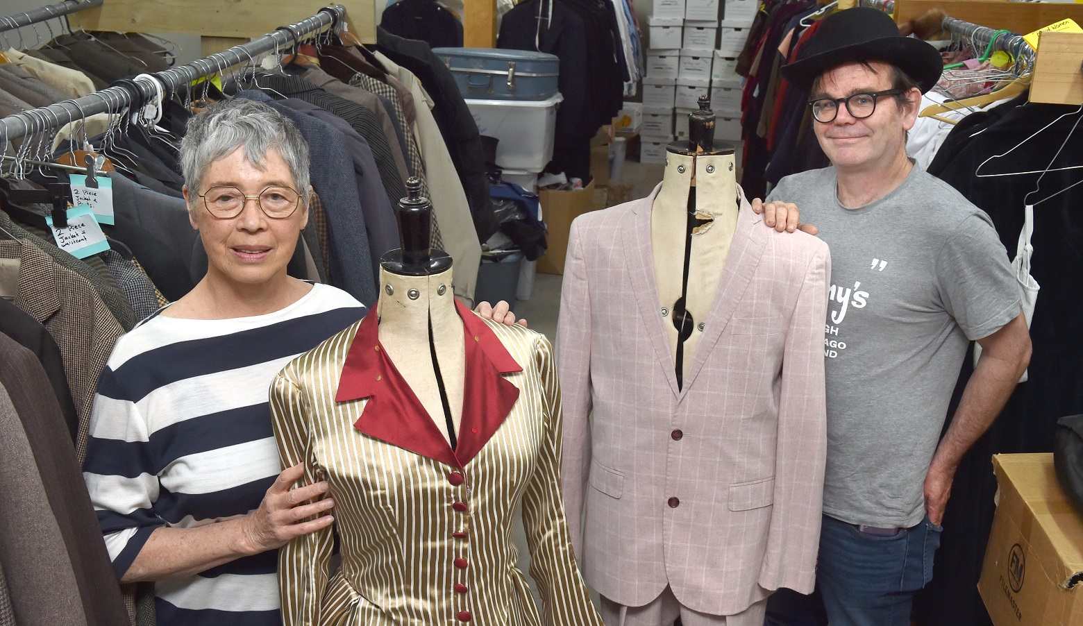 Stage South costume expert Charmian Smith and wardrobe volunteer Dan Eady prepare two costumes...