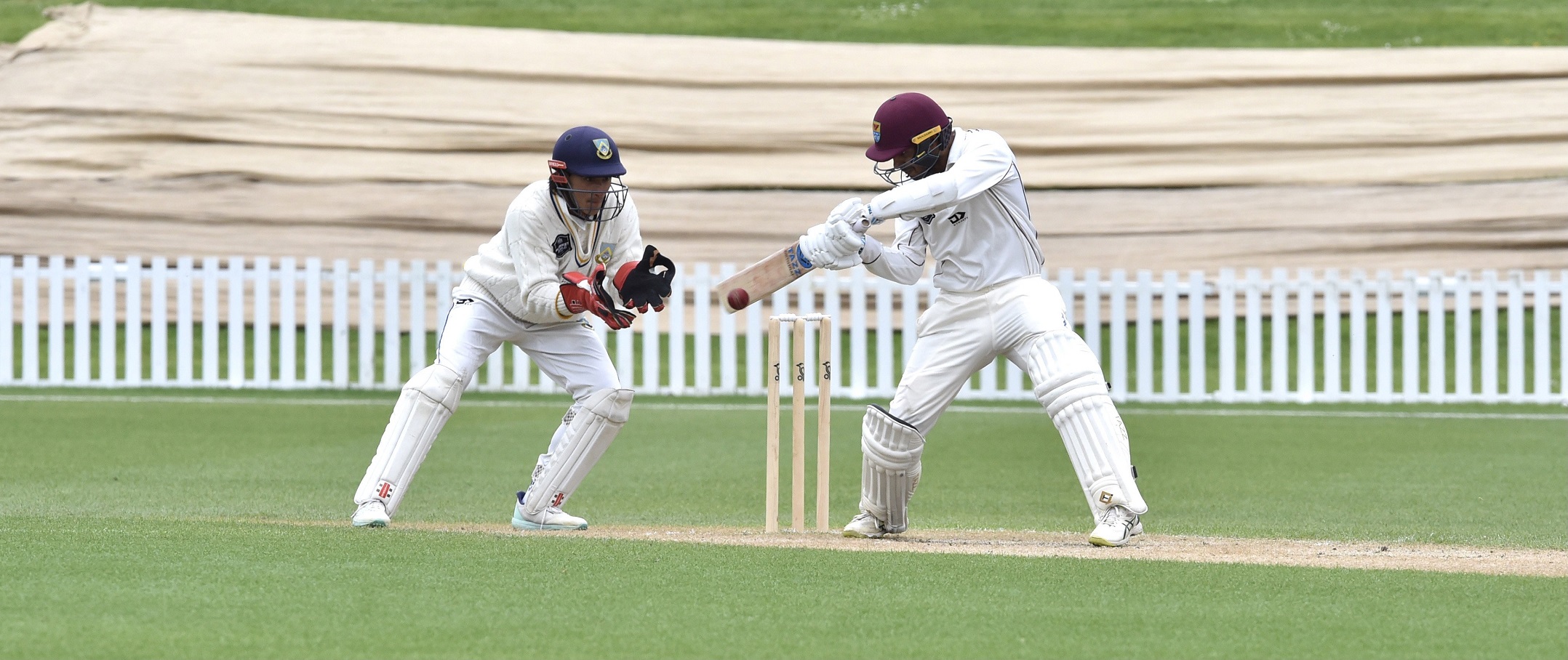 Northern District batsman Bharat Popli gets bat on ball as Otago Volts wicketkeeper Max Chu looks...