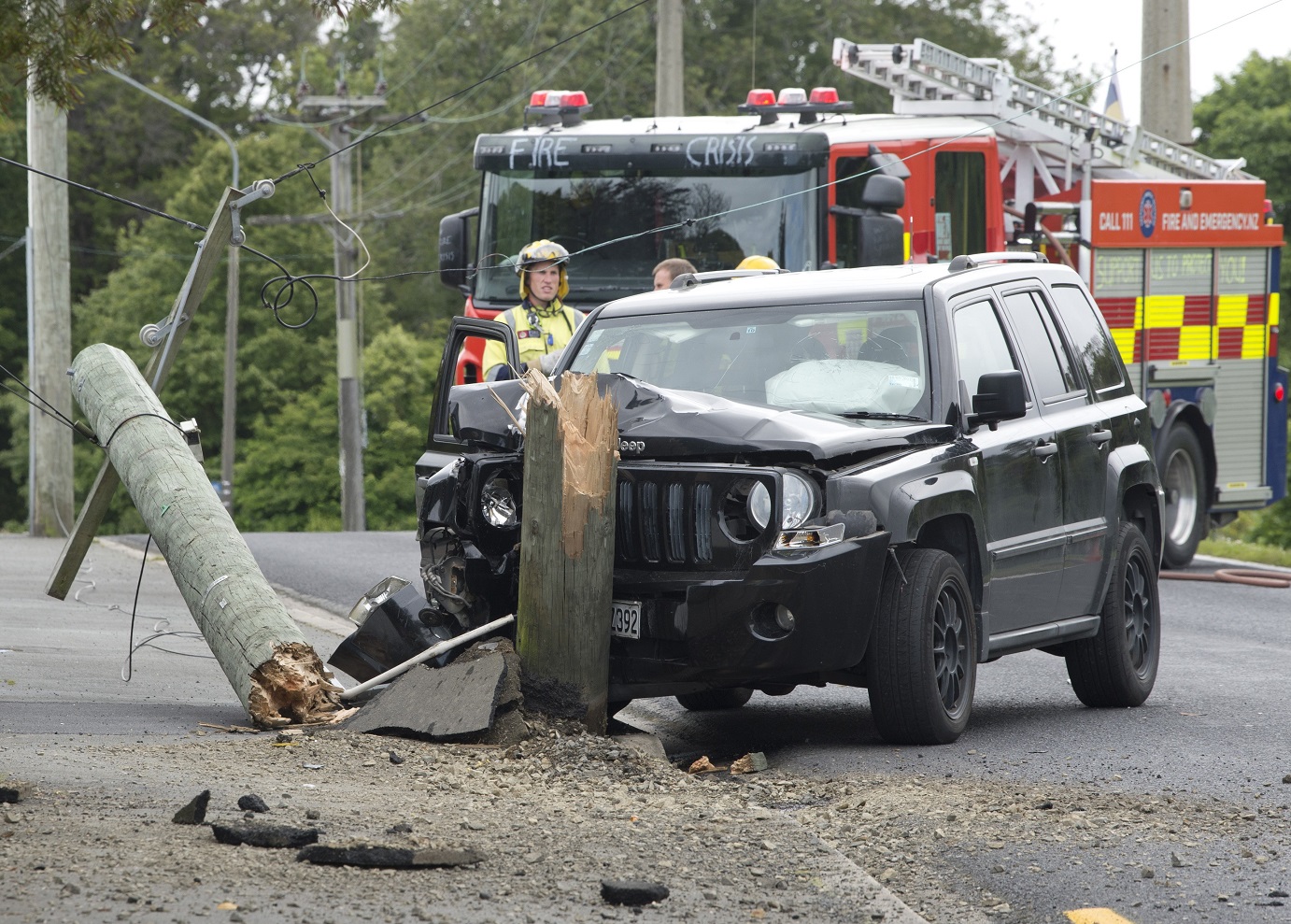 Fire and Emergency New Zealand attend the scene of a crash where a power line snapped in half...