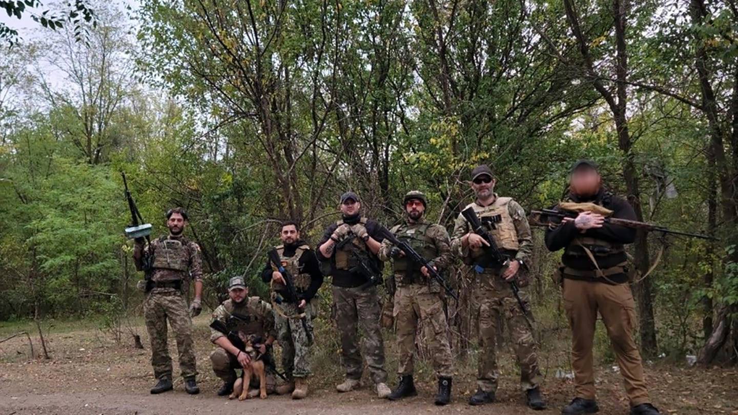 The ex-New Zealand Army member (right) with a group known as the Dark Angels of Ukraine. Photo:...