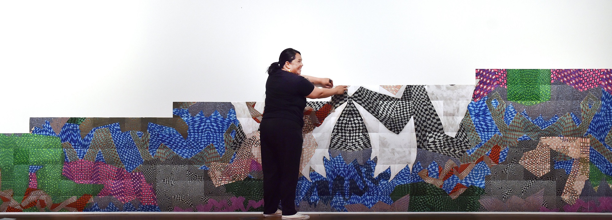 Artist Janet Lilo putting up her large photo mural at the Dunedin Public Art Gallery on Tuesday....