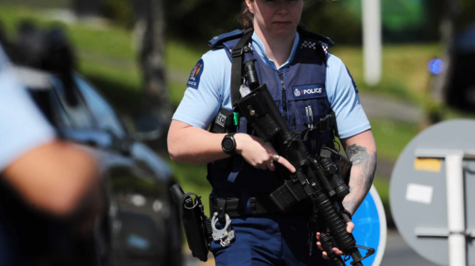 Armed police patrol Hutchinson Ave in New Lynn. Photo: NZ Herald