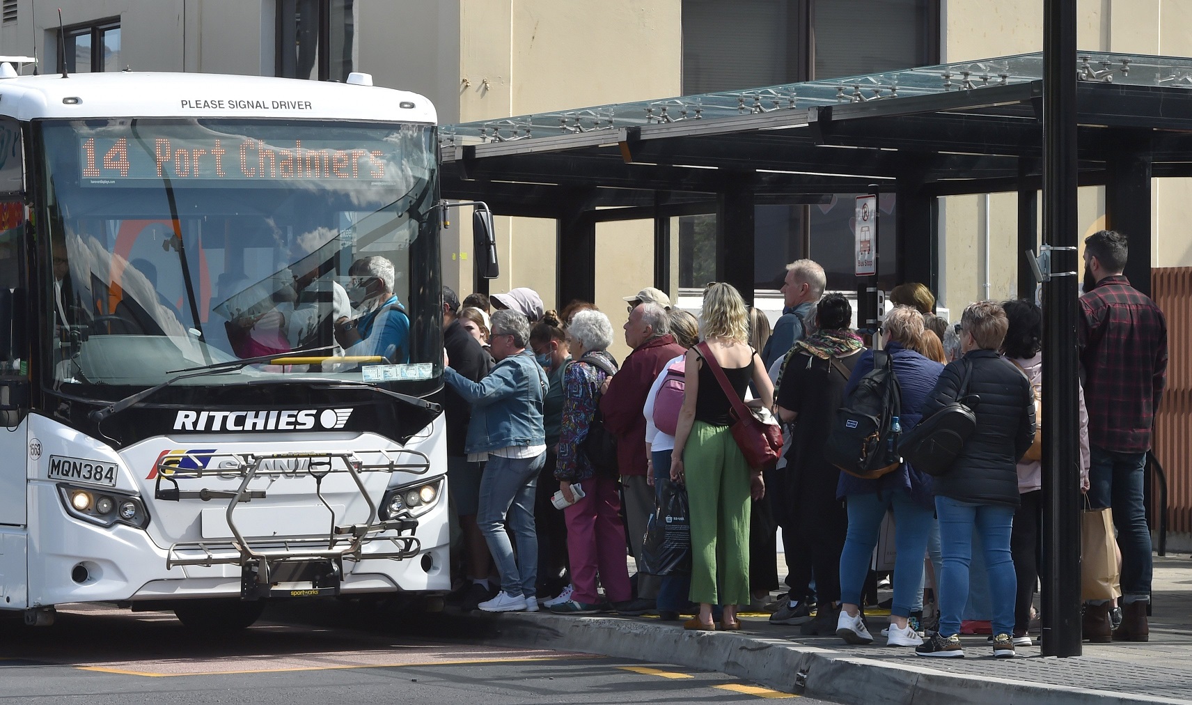 Cruise ship passengers and Dunedin residents wait to board the 3.31pm bus to Port Chalmers...