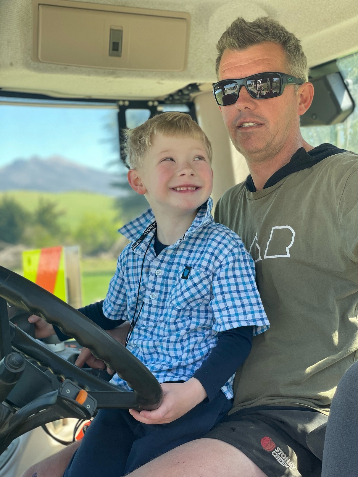 Luke Drummond plays on his father, Craig’s, tractor. Photo: Supplied