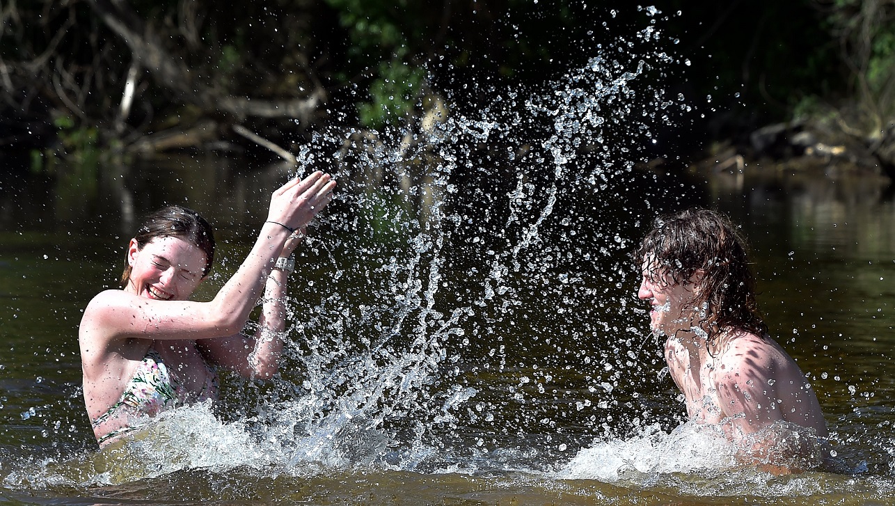 School pupils Rosa Smith and Ted Cottle (both 17) cool down at Outram Glen yesterday. Photos:...