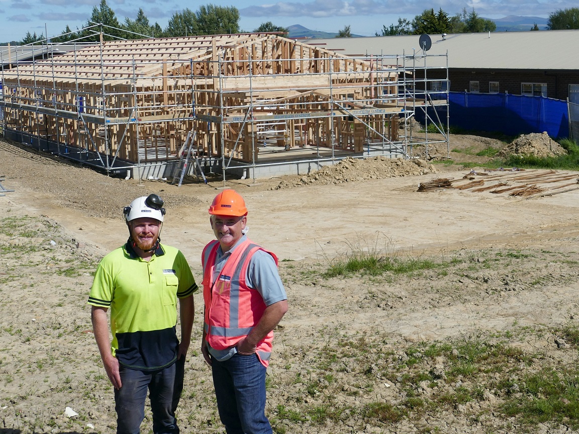 Cook Brothers Construction site manager James Feather (left) updates West Otago Health Ltd...