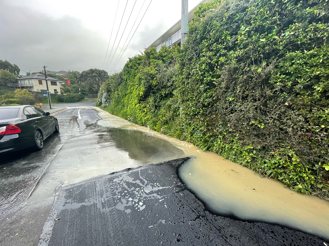 Water runs down Shandon Rd after a water main burst on Wednesday night, the second failure in...