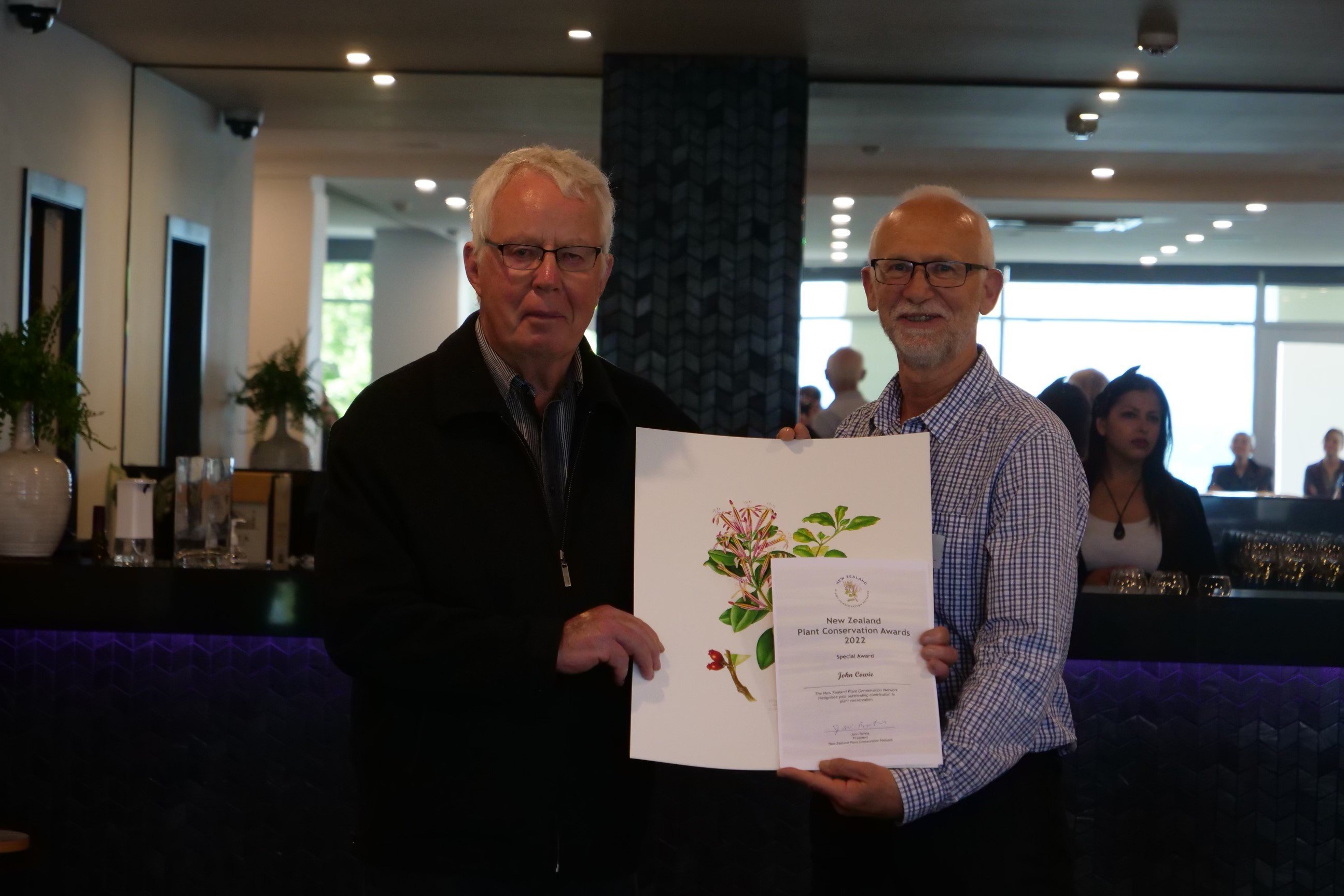 Southland farmer John Cowie (left) receives his award from the New Zealand Plant Conservation...