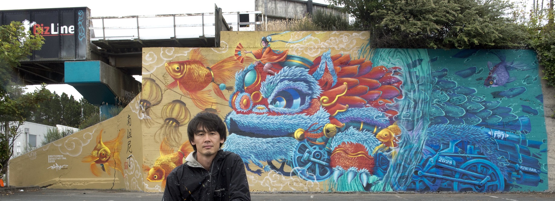 Street artist Koryu Aoshima with his near-complete work on the abutment of the King Edward St...