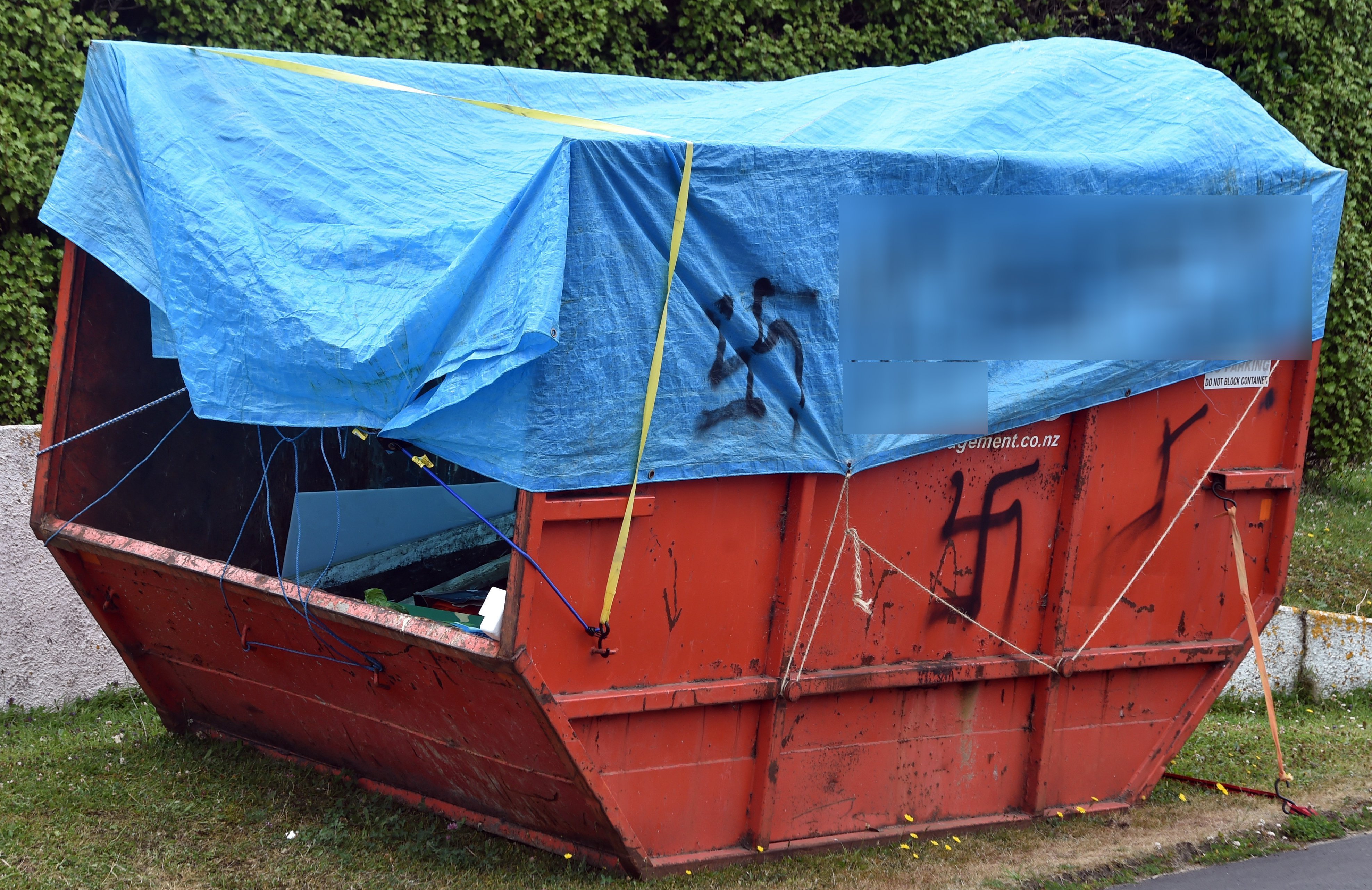 Police are investigating a large skip in Minto St, Andersons Bay, which was covered in racist...