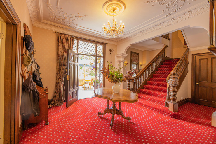 The property has an impressive hallway and staircase to upper floors. Photo: Supplied