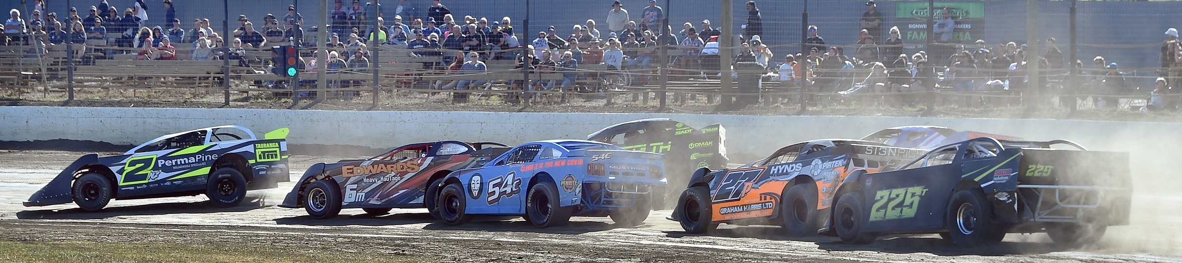 A series of super saloons race around a corner at Beachlands Speedway on Saturday. Photos: Peter...