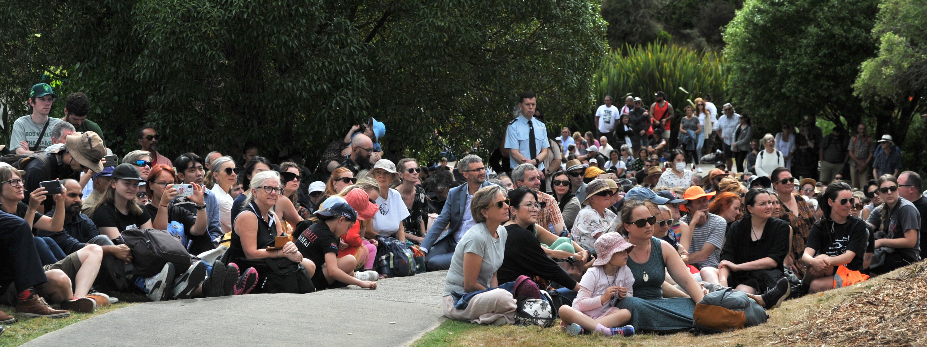 Visitors during the Ōtākou Marae Waitangi Day festivities take a seat on the lawn during the...