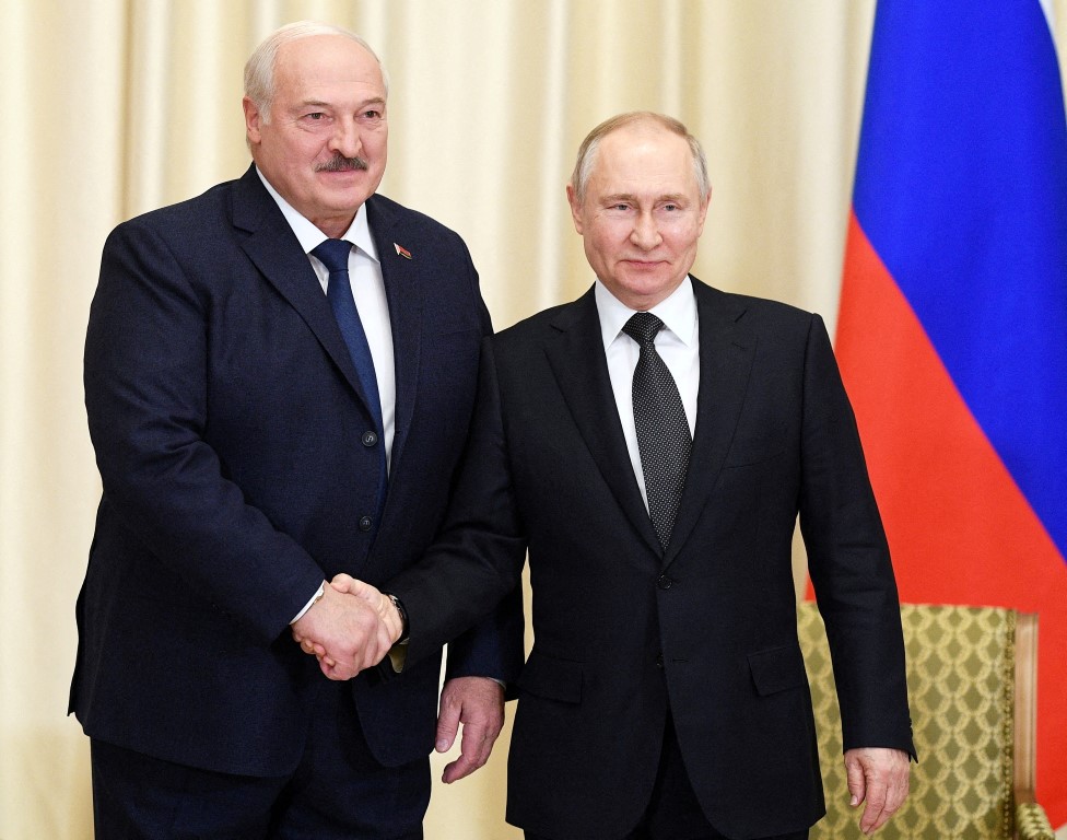 Russian President Vladimir Putin (R) shakes hands with Belarusian President Alexander Lukashenko...