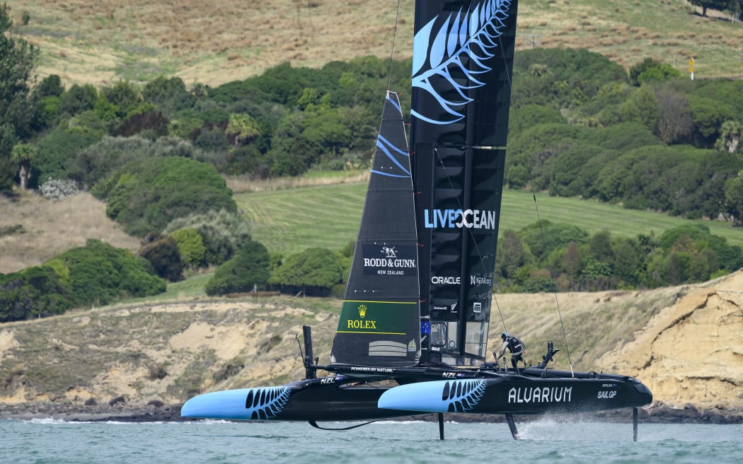 Andy Maloney, flight controller of New Zealand SailGP team, runs across the boat during a...