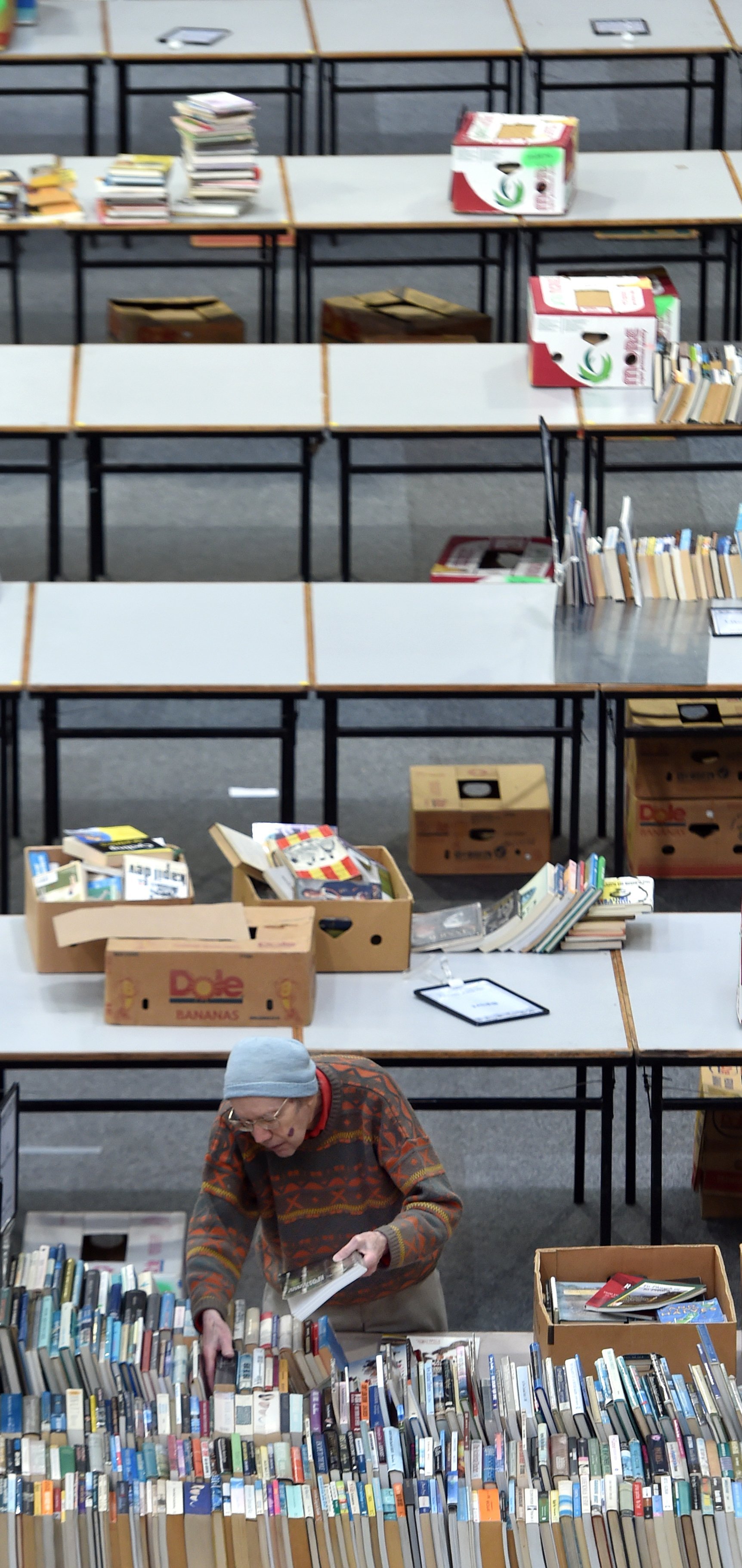 Volunteer Bill Cochrane lays out books on tables at the Edgar Centre yesterday.  PHOTO: PETER...