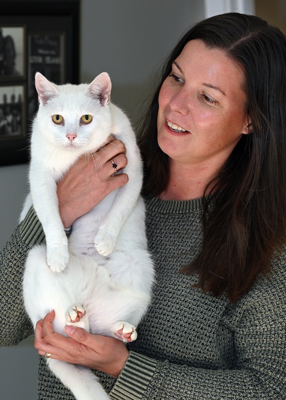 Christina McBratney with her cat, Buster, who has been returned after disappearing three years...