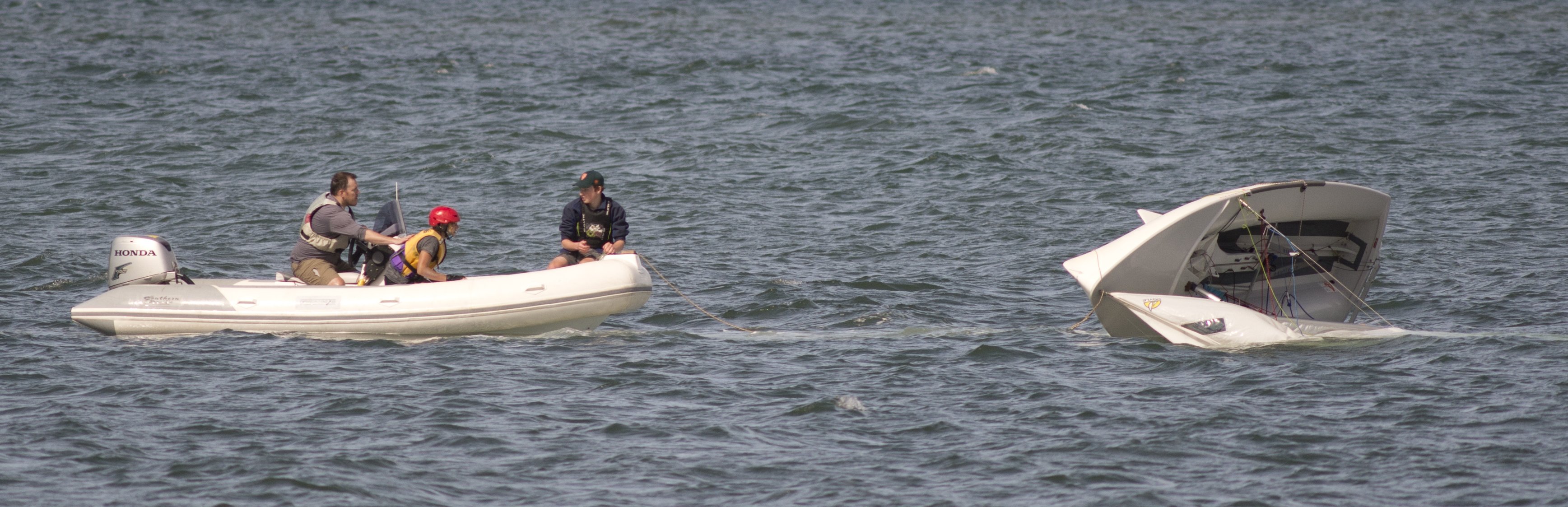 A rescue boat from the Otago Yacht Club assists a capsized vessel in Otago Harbour yesterday....