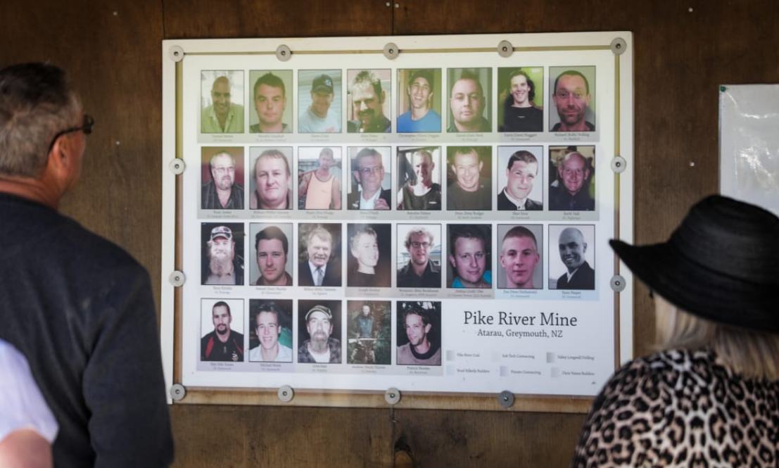 Relatives look at photos of the 29 men who died. Photo: RNZ (file)