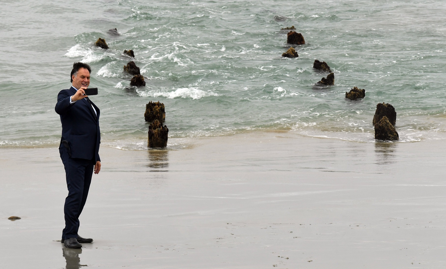 Dunedin Mayor Jules Radich takes a selfie with the stumps of the St Clair groyne poles in this...