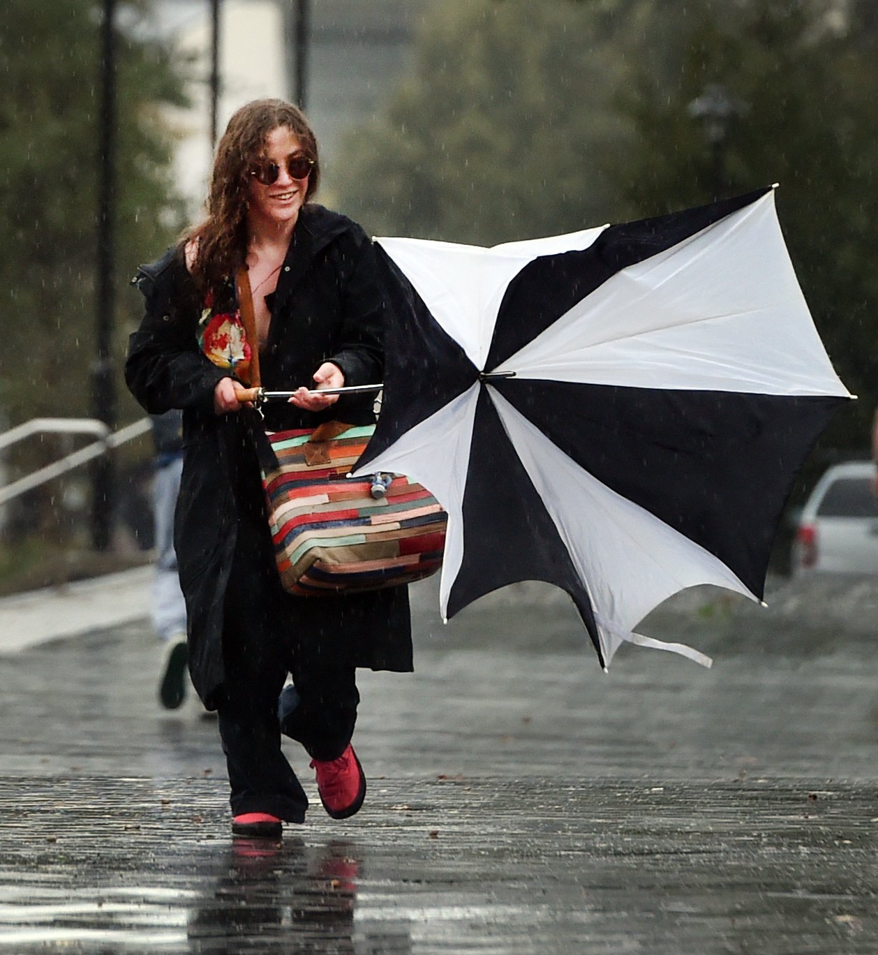 University of Otago student Sequoia Perkins (20) struggles to keep her umbrella in shape during...