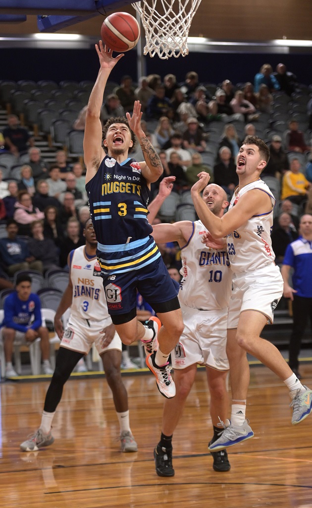 The Otago Nuggets’ JaQuori McLaughlin goes for a dunk as Nelson Giants players (from left) Avery...