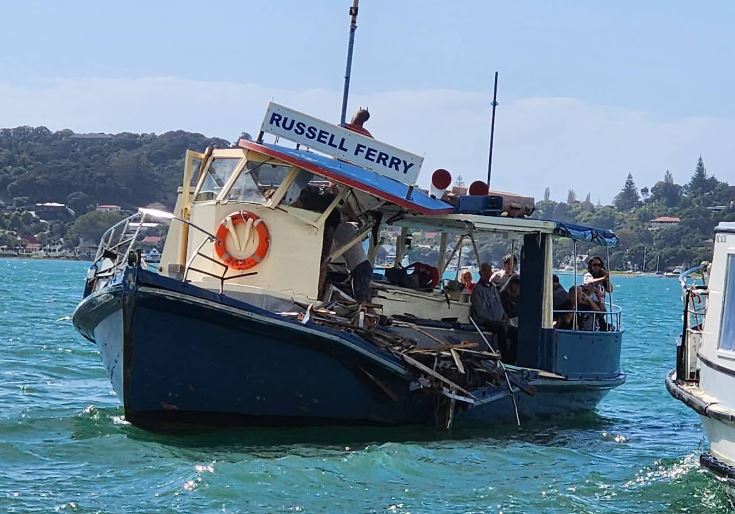 Passengers on the stricken Blue Ferry wait to be rescued by the Happy Ferry. Photo: Elliot Bexon