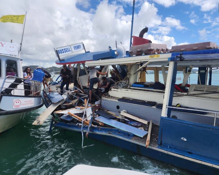 Passengers on the stricken Blue Ferry clamber over wreckage to the safety of the Happy Ferry...