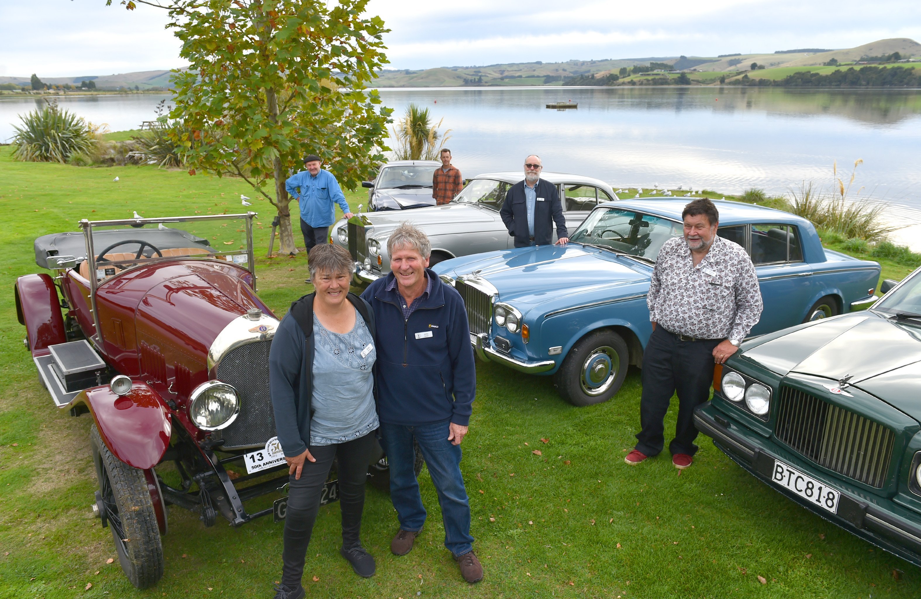 Katy and John Parish stand beside their 1923 Bentley 3-litre TT. They are joined by (rear, from...