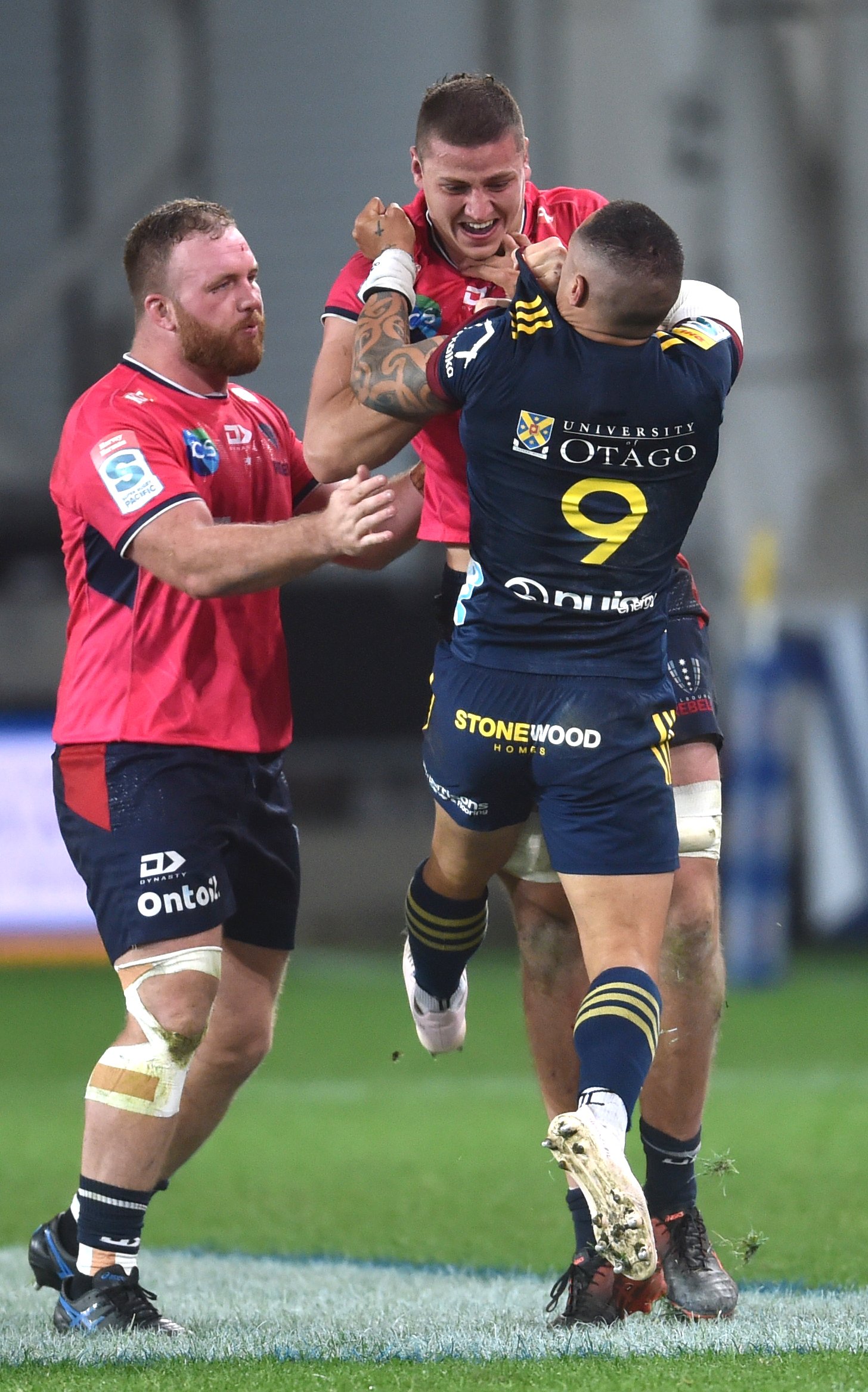 Highlanders halfback Aaron Smith tussles with Rebels lock Josh Canham at Forsyth Barr Stadium on...