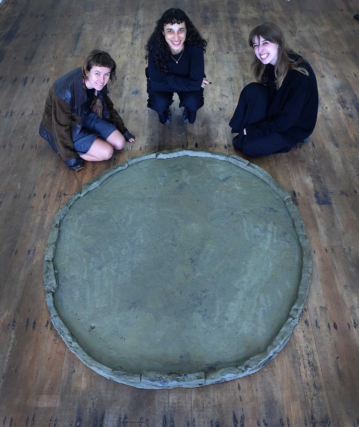 Artists (from left) Lucy Hill, Yana Dombrowsky-M’Baye and Taarn Scott look at Dombrosky-M’Baye’s...