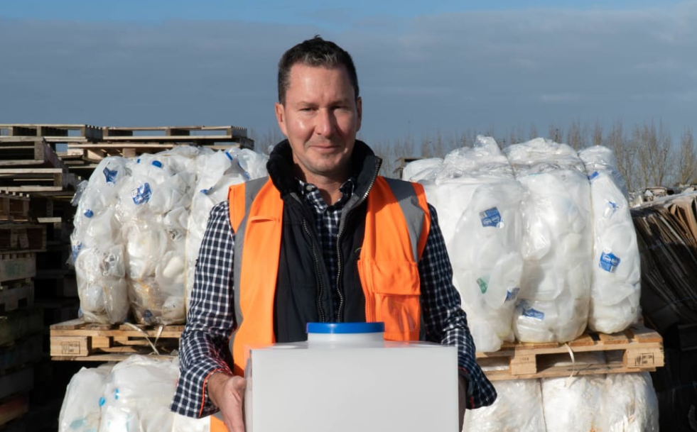 Green Valley Dairies general manager Mark Pulman holds a refillable milk keg. He says farmers are...