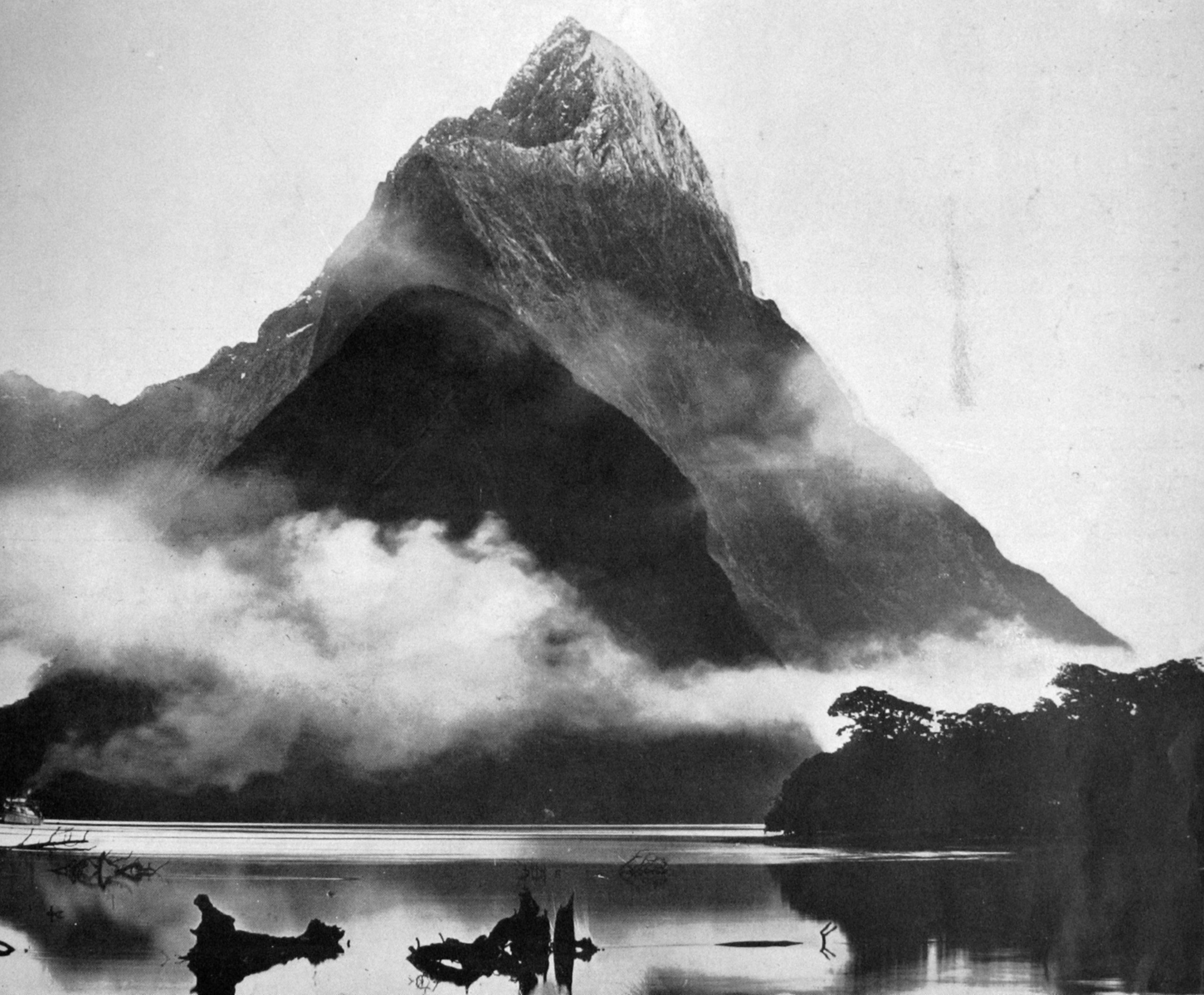 Early morning mists in Milford Sound, West Coast of Otago.  View taken as the sun topped Mitre...