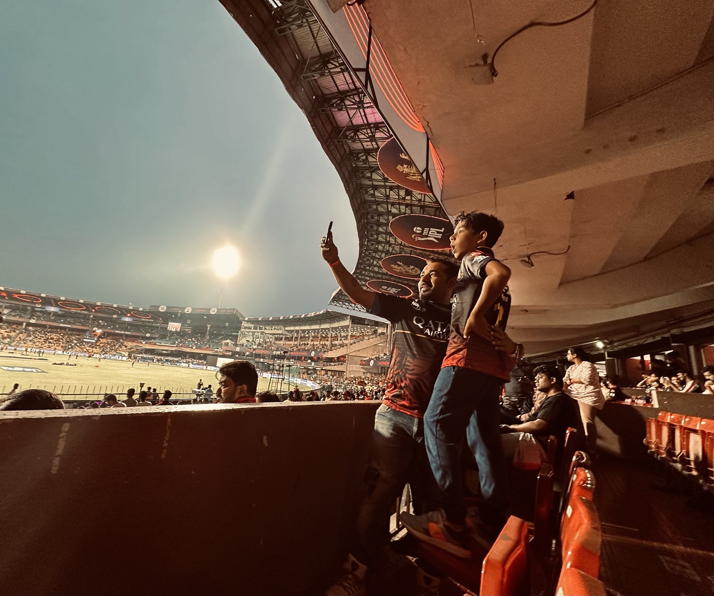 Father and son take a selfie as the crowd builds at a game at M. Chinnaswamy Stadium in Bangalore...