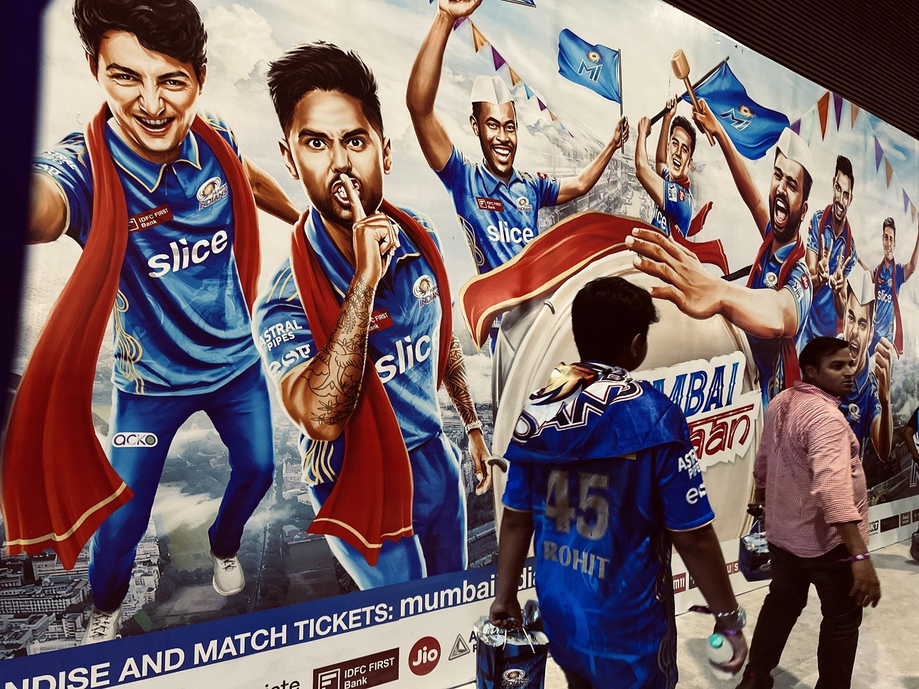 Fans walk past a poster of star Mumbai players. Photo: supplied