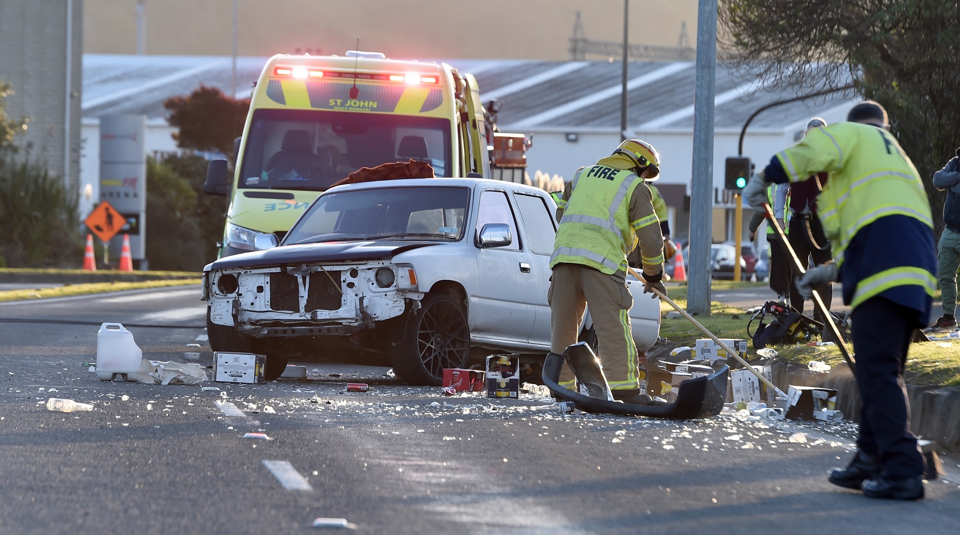 Emergency services sweep up glass and other debris after a crash in Portsmouth Dr this afternoon....