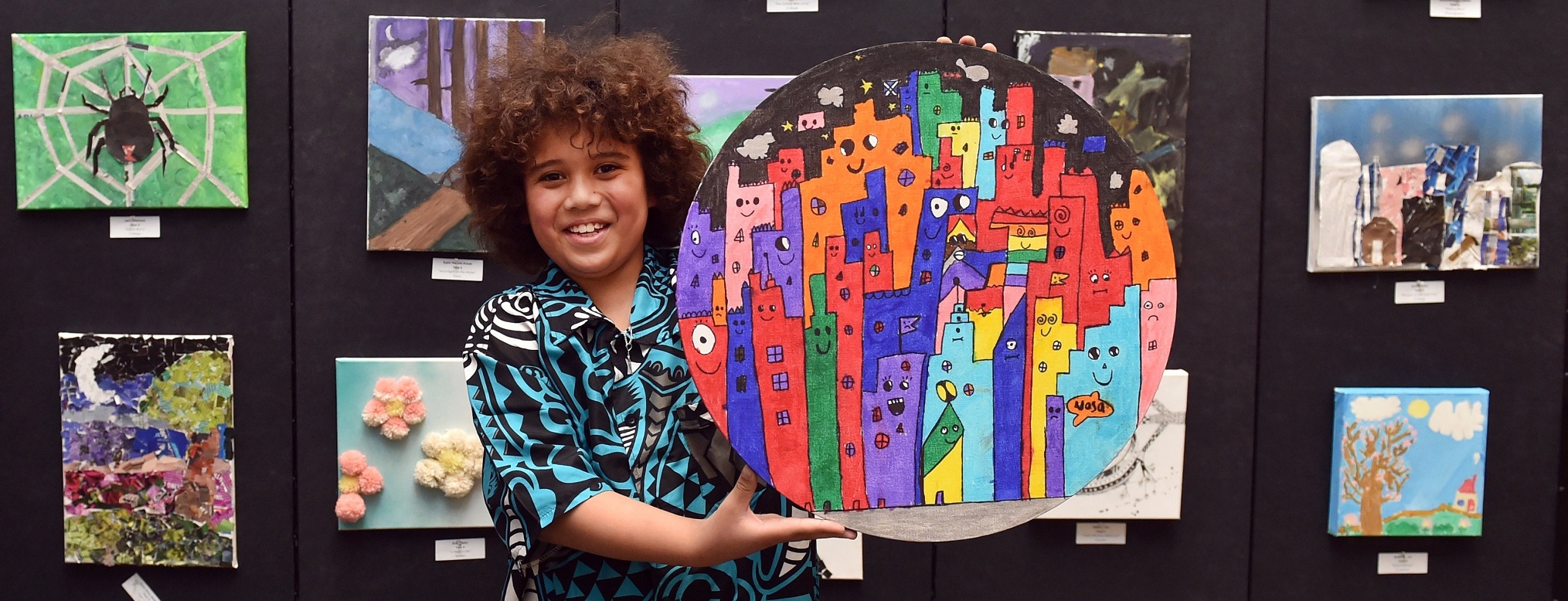 Thomas Matthews-Nielson (8) holds his art work during the St Joseph’s Cathedral School art...