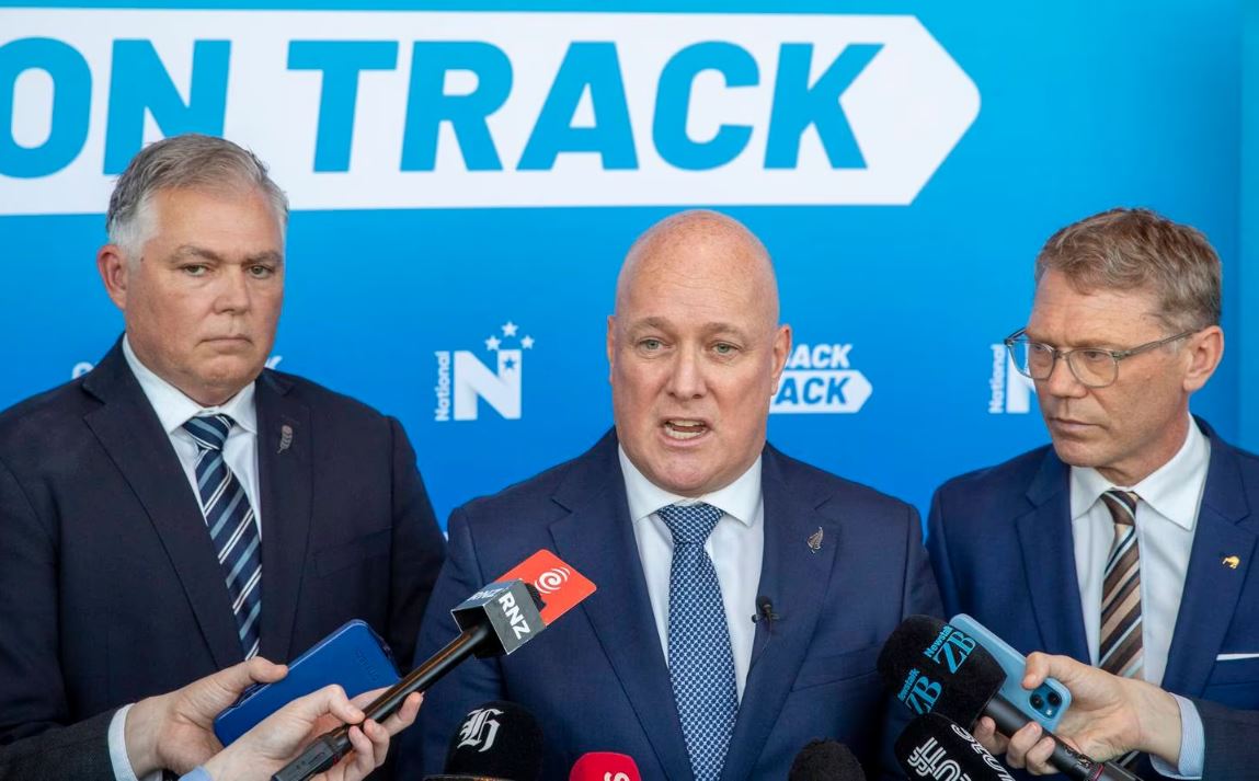 National leader Christopher Luxon, flanked by police spokesman Mark Mitchell (left) and justice...