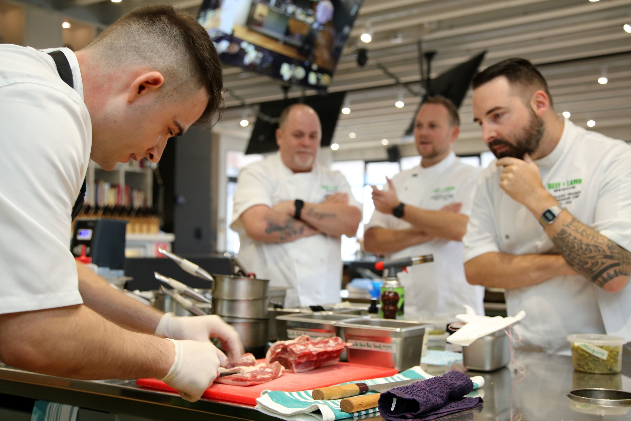 Nic Kearney (left) was the only finalist to prep his protein in front of the judges (from left)...