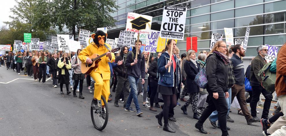 Participants march through the University of Otago campus at a recent protest against cuts at the...