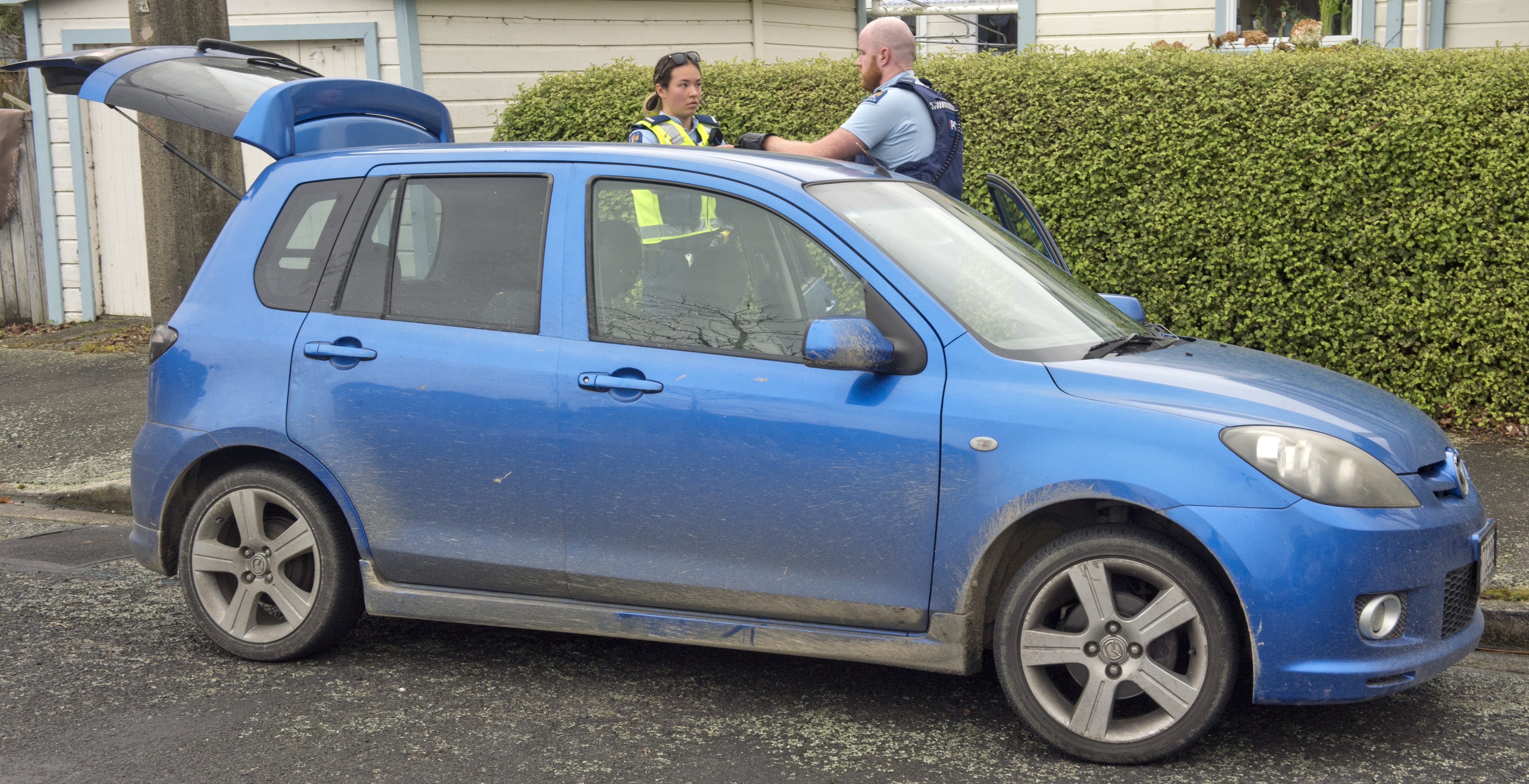 Police examine a stolen Mazda Demio recovered in Beechworth St, North East Valley, yesterday...