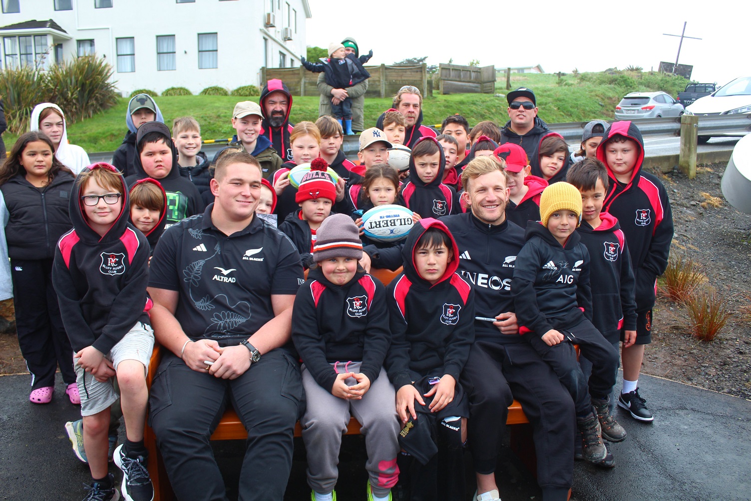 All Blacks Ethan de Groot (left) and Damian McKenzie, supported by Bluff Rugby Club players and...