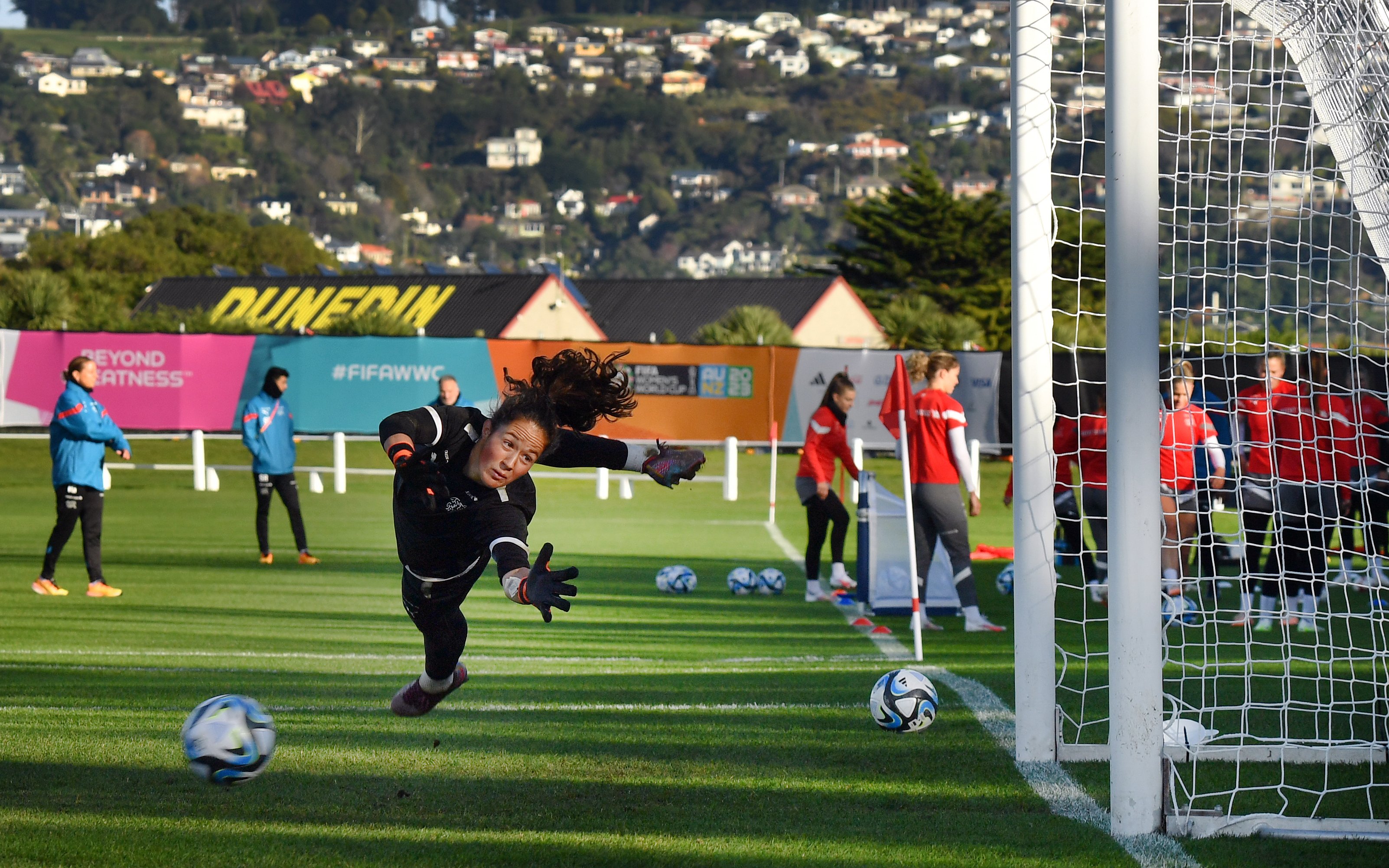 Switzerland goalkeeper Livia Peng dives for the ball during a training session at Tahuna Park, in...