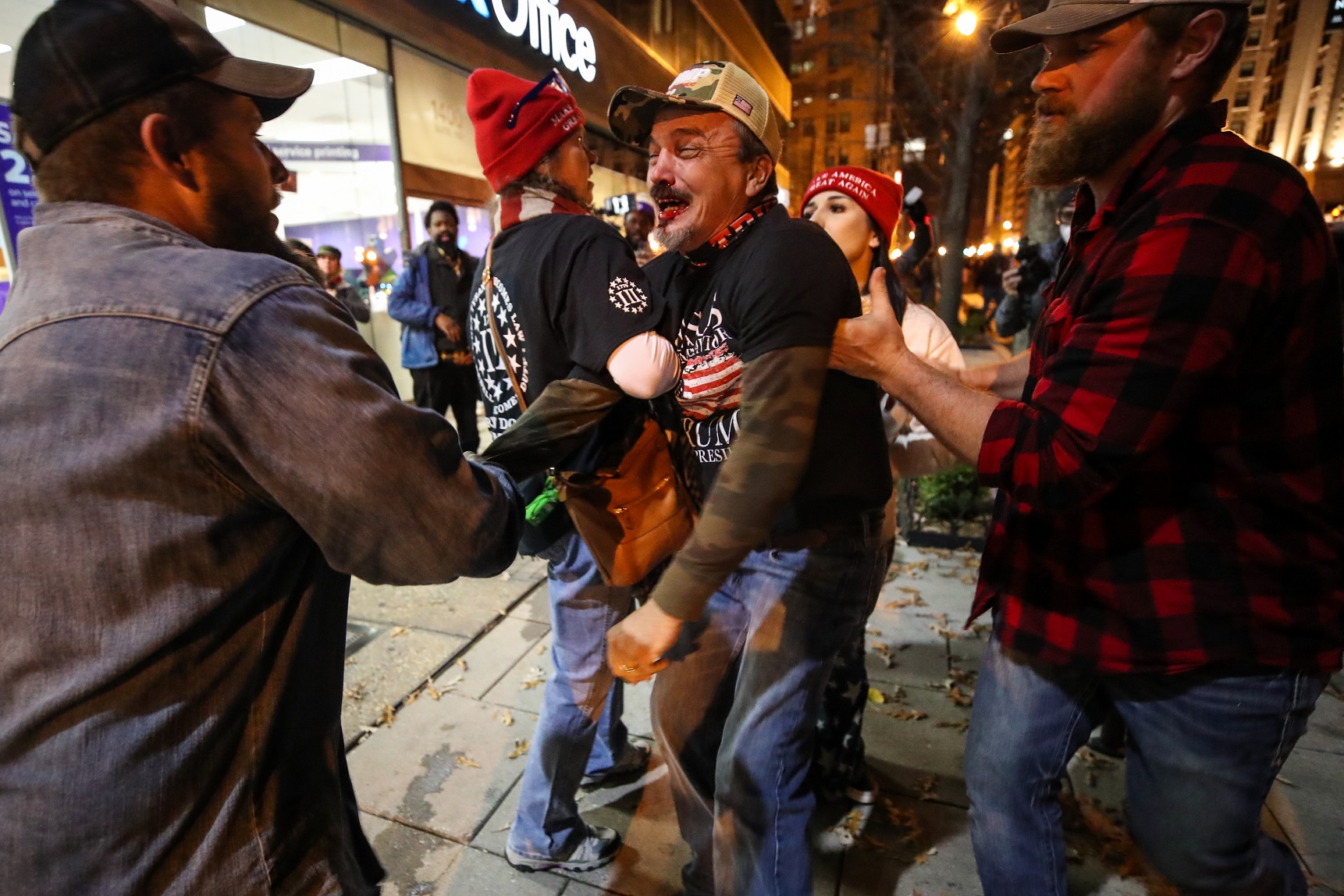 Members of the Proud Boys brawl after a Trump rally.